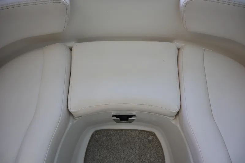 Slide: The Image of 2009 Chaparral Sunesta 244 boat interior seating with white upholstery. - 8