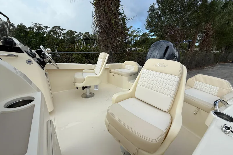 Slide: The Image of 2026 Scout 188 Sport Dorado boat interior with cream seating and steering console. - 11