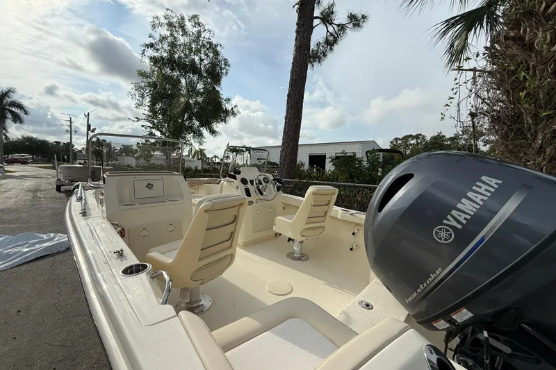 Slide: The Image of 2026 Scout 188 Sport Dorado boat with Yamaha outboard motor, parked outdoors. - 2