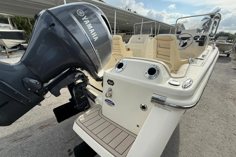 Slide: The Image of 2026 Scout 188 Sport Dorado boat with Yamaha outboard motor, parked outdoors. - 3