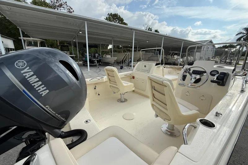 Slide: The Image of 2026 Scout 188 Sport Dorado boat interior with Yamaha engine, showcasing seating and controls. - 4