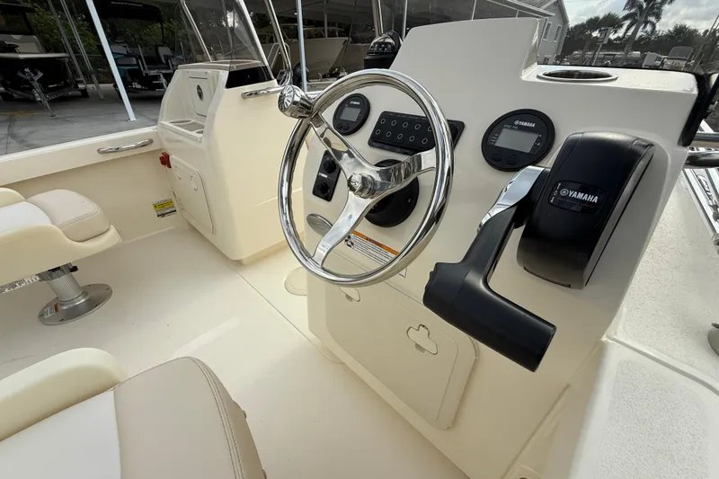 Slide: The Image of 2026 Scout 188 Sport Dorado boat helm with Yamaha controls and steering wheel. - 5