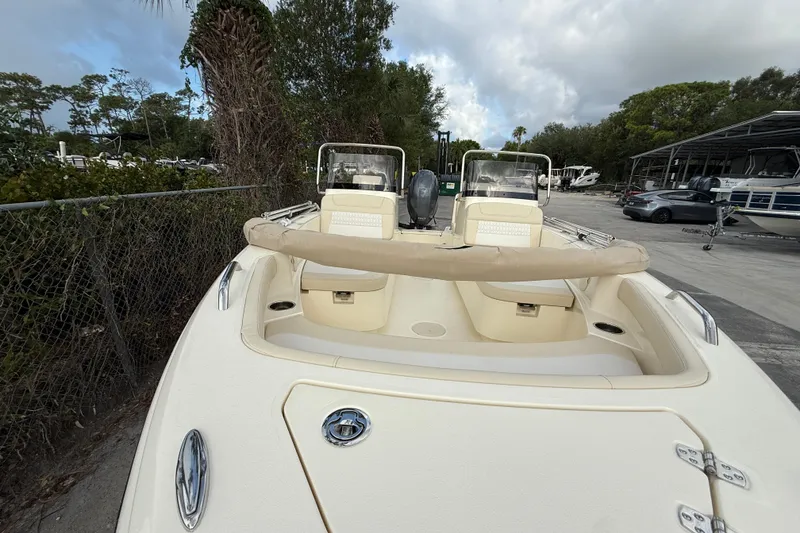 Slide: The Image of 2026 Scout 188 Sport Dorado boat docked, showcasing sleek design and dual seating. - 9