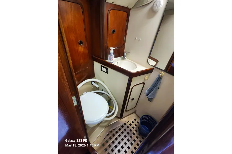 Slide: The Image of Bathroom interior of 1986 Beneteau Idylle 15.50 yacht with wooden accents. - 16
