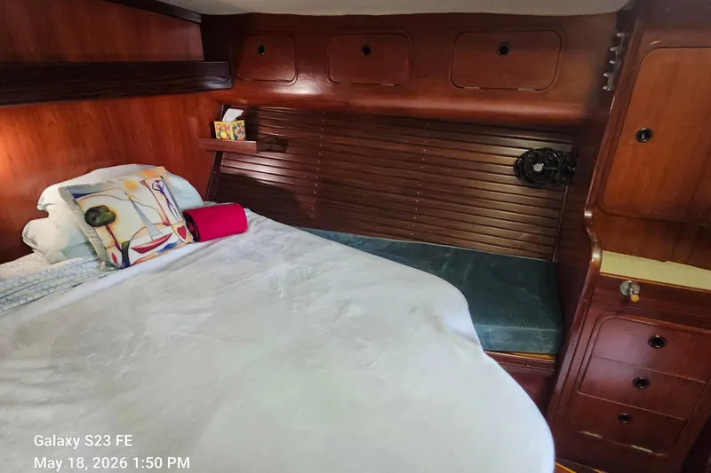 Slide: The Image of Cozy cabin interior of 1986 Beneteau Idylle 15.50 sailboat with wooden finish and bedding. - 19
