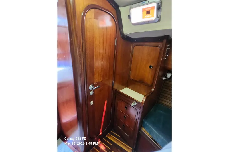 Slide: The Image of Interior of 1986 Beneteau Idylle 15.50 sailboat with wooden cabinetry and storage. - 21