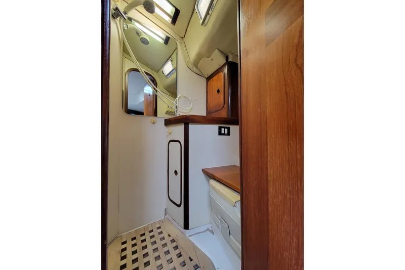 Slide: The Image of Interior of 1986 Beneteau Idylle 15.50 yacht bathroom with wooden accents and shower. - 22
