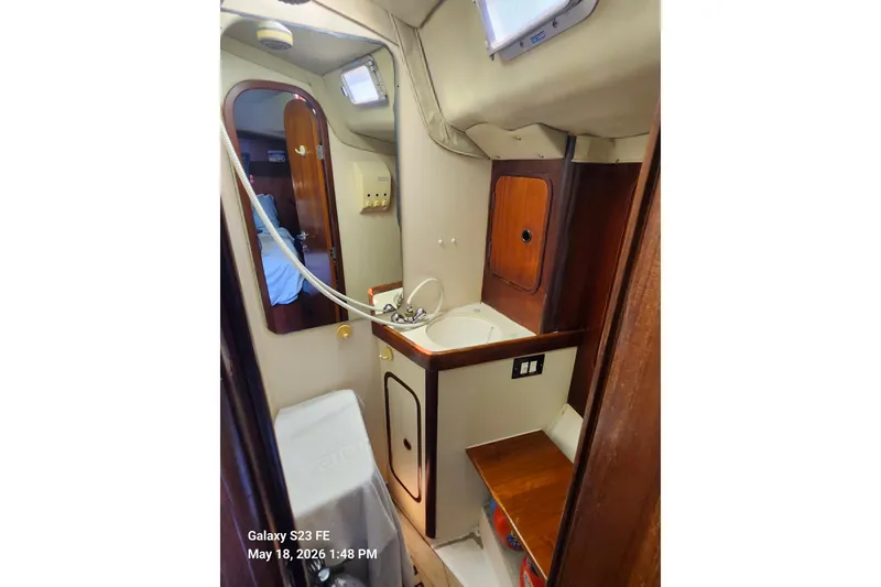 Slide: The Image of Interior of 1986 Beneteau Idylle 15.50 yacht bathroom with sink and mirror. - 23