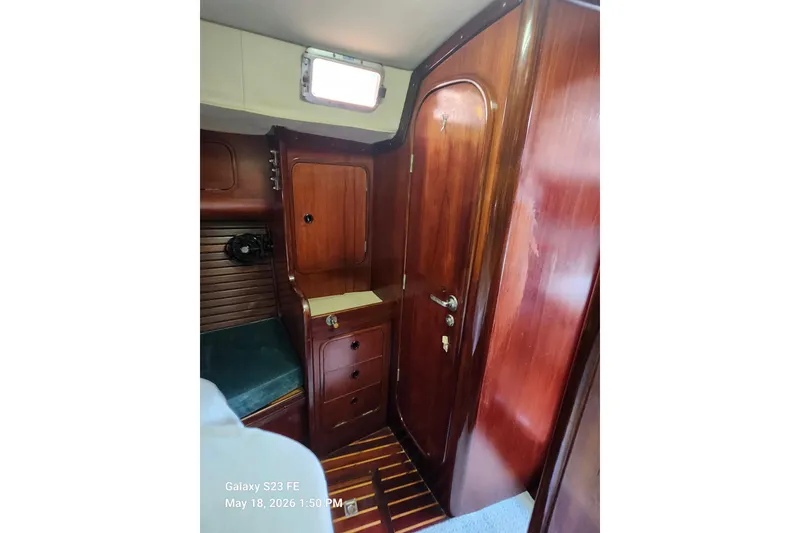 Slide: The Image of Interior of 1986 Beneteau Idylle 15.50 yacht with wooden cabinetry and door. - 25