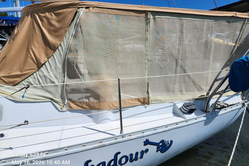 Slide: The Image of 1986 Beneteau Idylle 15.50 sailboat with beige canopy docked at marina. - 27