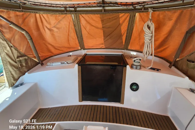 Slide: The Image of Cockpit of 1986 Beneteau Idylle 15.50 sailboat with orange canopy and wooden flooring. - 35