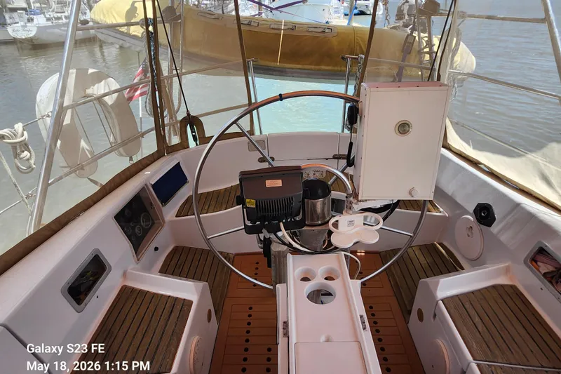 Slide: The Image of Cockpit of 1986 Beneteau Idylle 15.50 sailboat with steering wheel and navigation equipment. - 36