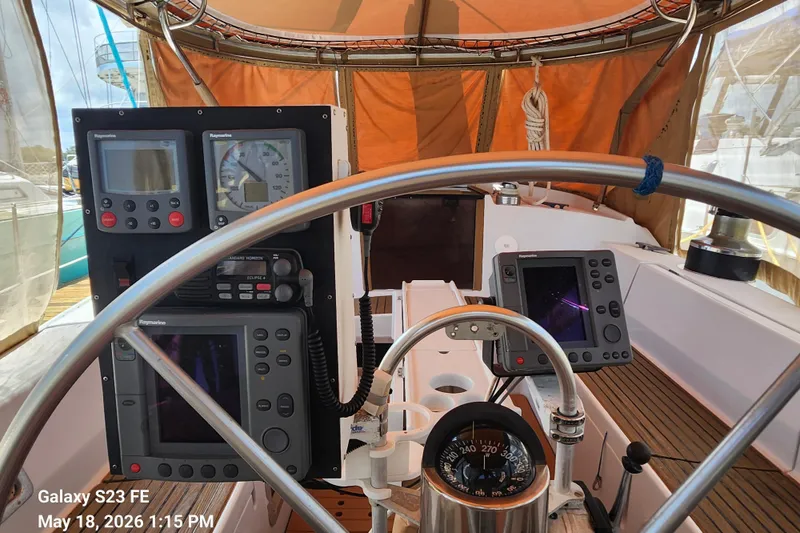Slide: The Image of Cockpit of 1986 Beneteau Idylle 15.50 sailboat with navigation instruments and compass. - 38