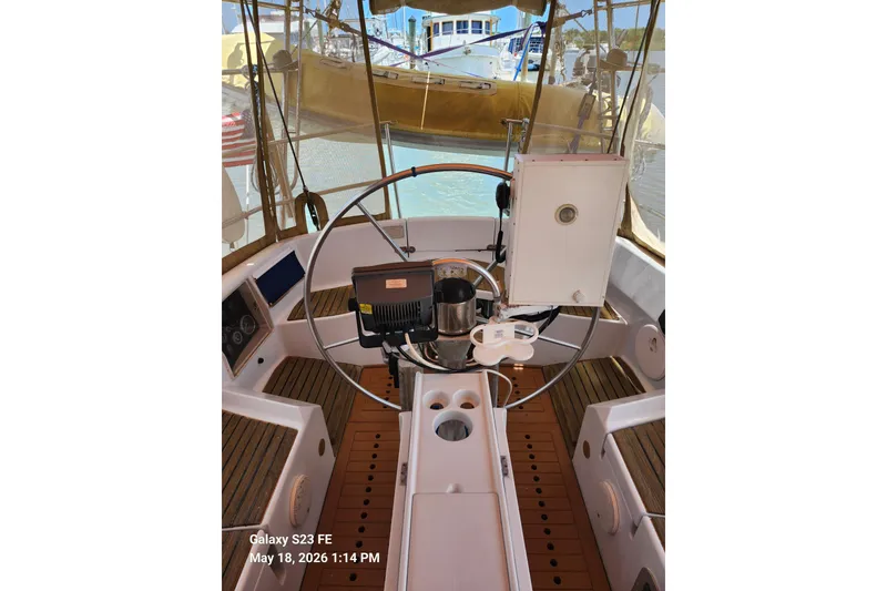 Slide: The Image of Cockpit of 1986 Beneteau Idylle 15.50 sailboat with steering wheel and navigation equipment. - 4