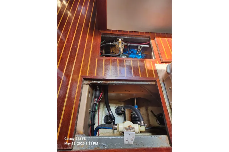 Slide: The Image of Engine compartment of 1986 Beneteau Idylle 15.50 sailboat with visible mechanical components. - 42