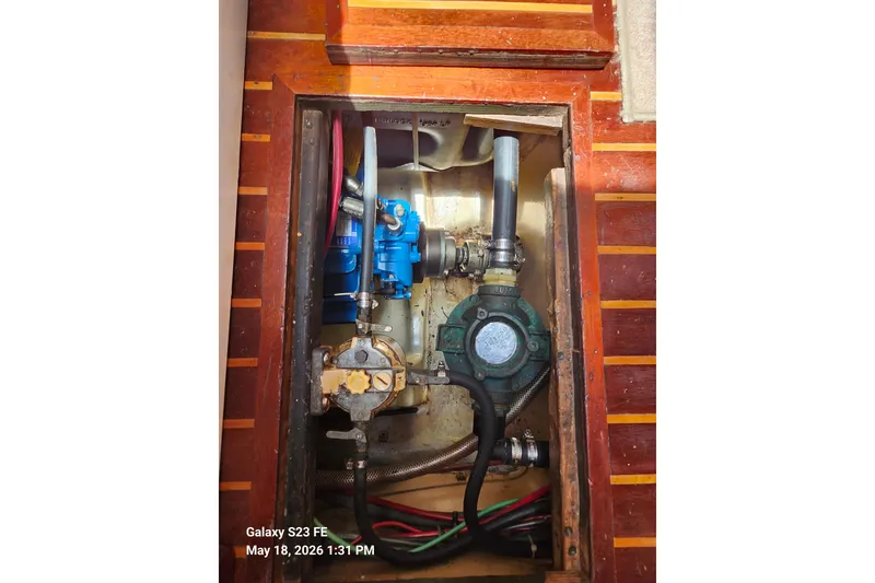 Slide: The Image of Engine compartment of a 1986 Beneteau Idylle 15.50 sailboat, showcasing mechanical components. - 43