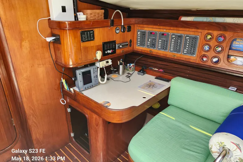 Slide: The Image of Navigation station inside a 1986 Beneteau Idylle 15.50 yacht, featuring control panels and seating. - 45