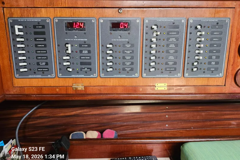 Slide: The Image of Electrical control panel on a 1986 Beneteau Idylle 15.50 sailboat, featuring various switches and displays. - 47