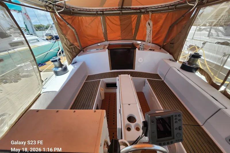 Slide: The Image of Cockpit of 1986 Beneteau Idylle 15.50 sailboat with navigation equipment and seating. - 5