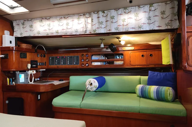 Slide: The Image of Interior of 1986 Beneteau Idylle 15.50 yacht with green seating and nautical decor. - 7