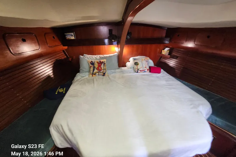 Slide: The Image of Cozy cabin interior of 1986 Beneteau Idylle 15.50 sailboat with wooden paneling and bed. - 9