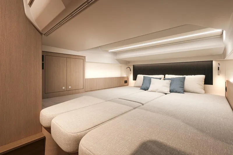 Slide: The Image of Luxurious interior cabin of 2026 Beneteau Grand Turismo 35 yacht, featuring modern design and cozy bedding. - 15