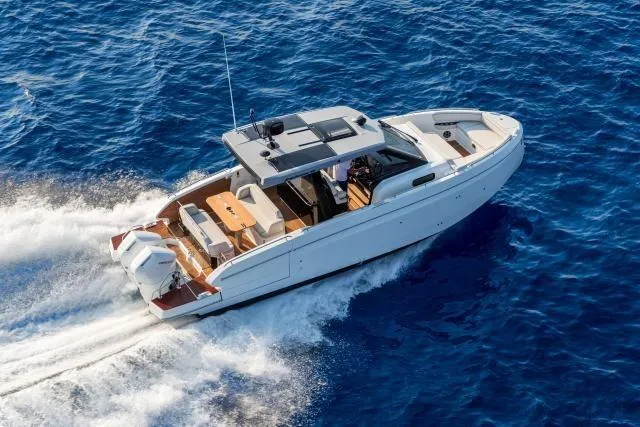 Slide: The Image of 2026 Beneteau Gran Turismo 35 cruising on open blue sea, showcasing sleek design and performance. - 4