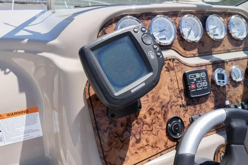 Slide: The Image of Dashboard of a 2005 Larson Cabrio 290 boat with navigation equipment and gauges. - 12
