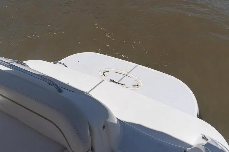 Slide: The Image of Rear view of a 2005 Larson Cabrio 290 boat with swim platform on water. - 5