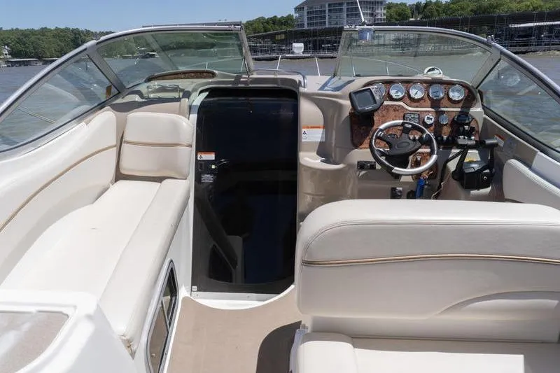 Slide: The Image of 2005 Larson Cabrio 290 boat interior with steering wheel and dashboard controls. - 8