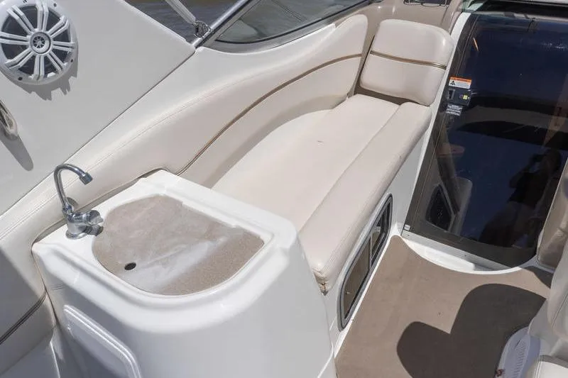 Slide: The Image of 2005 Larson Cabrio 290 boat interior with seating and sink area. - 9