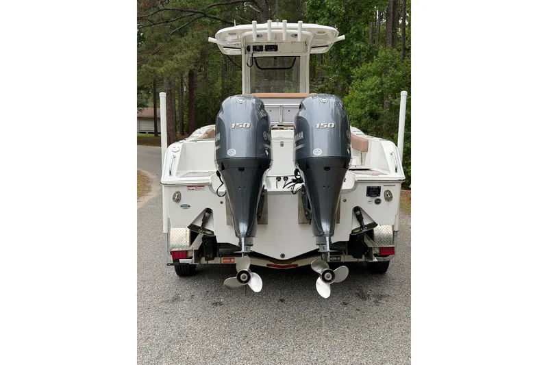 Slide: The Image of 2019 Sea Hunt Gamefish 25 boat with dual Yamaha 150 engines on a trailer. - 1