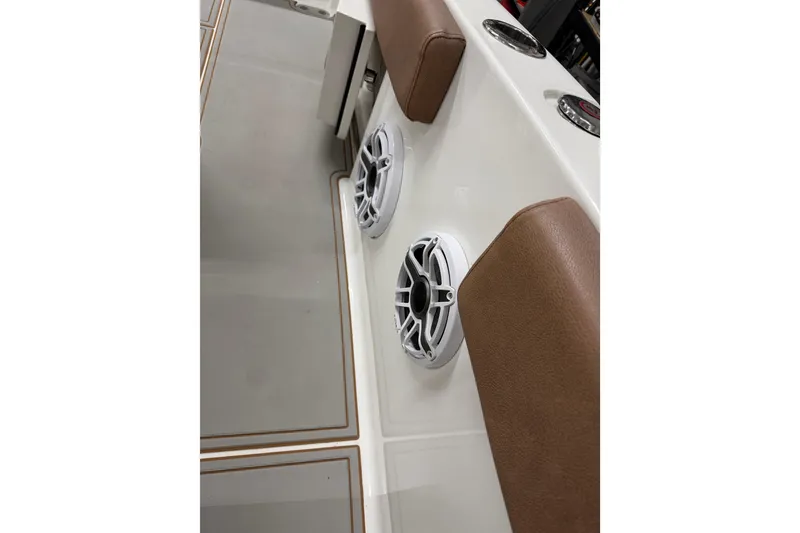 Slide: The Image of 2019 Sea Hunt Gamefish 25 boat interior with speakers and cushioned seating. - 14