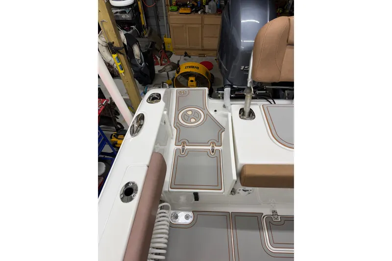 Slide: The Image of 2019 Sea Hunt Gamefish 25 boat interior with seating and fishing equipment. - 19