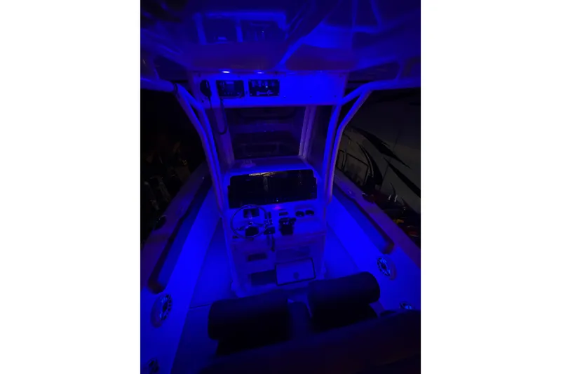 Slide: The Image of 2019 Sea Hunt Gamefish 25 boat interior illuminated with blue lighting. - 26