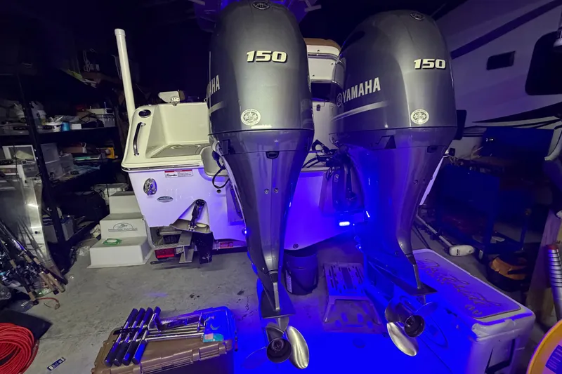 Slide: The Image of 2019 Sea Hunt Gamefish 25 with dual Yamaha 150 engines in a garage setting. - 27