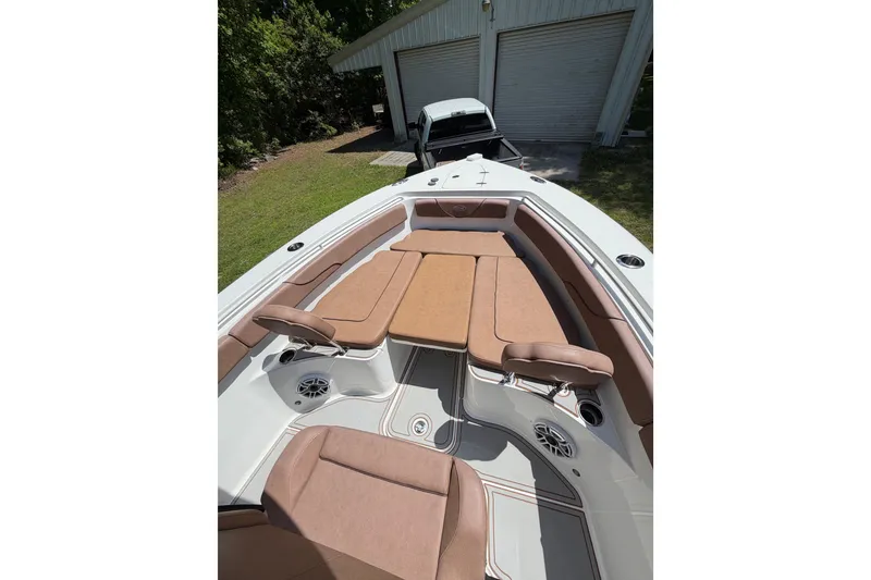 Slide: The Image of 2019 Sea Hunt Gamefish 25 boat with tan seating and spacious deck layout. - 33
