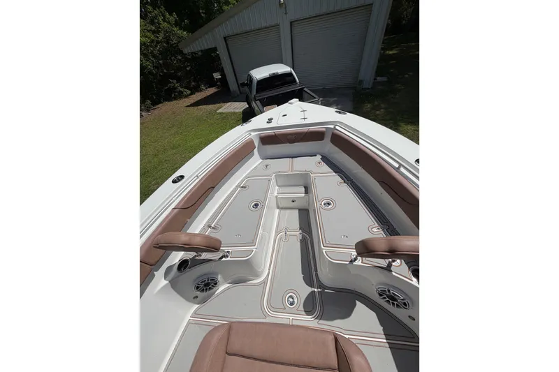 Slide: The Image of 2019 Sea Hunt Gamefish 25 boat interior with brown seating and sleek design. - 35
