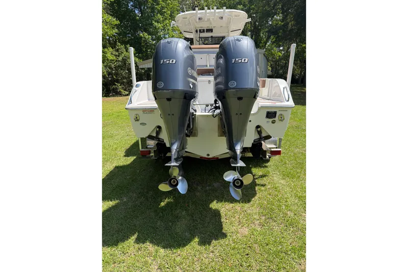 Slide: The Image of 2019 Sea Hunt Gamefish 25 boat with dual Yamaha 150 engines on grass. - 38
