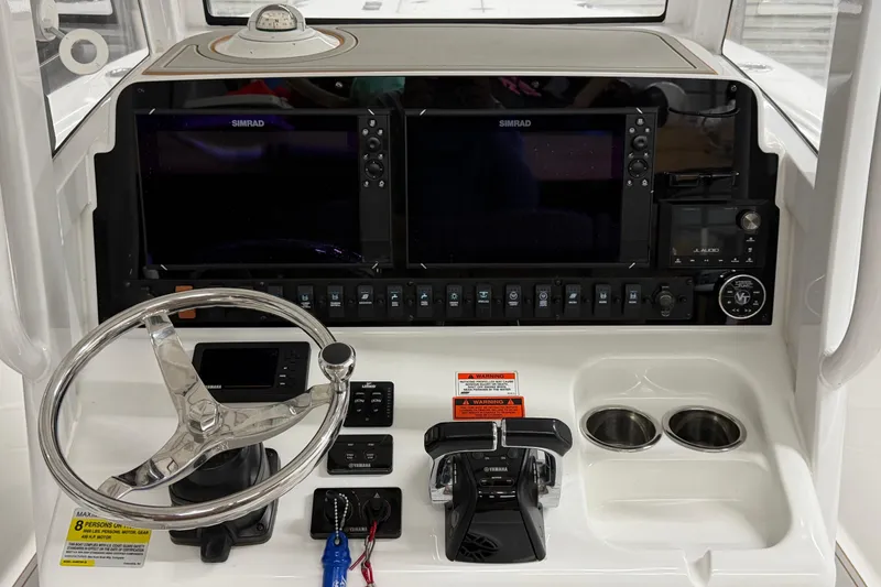 Slide: The Image of 2019 Sea Hunt Gamefish 25 helm with dual Simrad displays and Yamaha controls. - 9