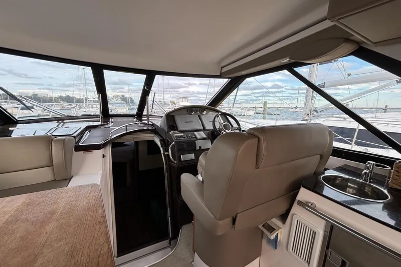 Slide: The Image of Interior of a 2015 Regal 42 Sport Coupe yacht with helm and seating area. - 12