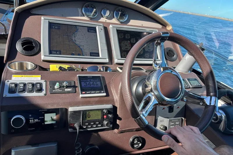 Slide: The Image of Cockpit of 2015 Regal 42 Sport Coupe with navigation screens and steering wheel. - 15