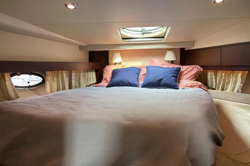 Slide: The Image of Luxurious bedroom interior of 2015 Regal 42 Sport Coupe yacht with skylight and cozy bedding. - 22