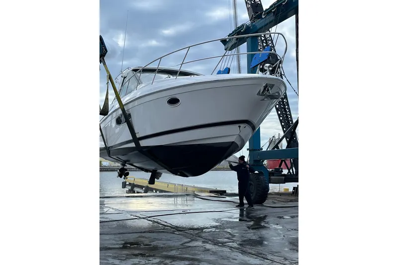 Slide: The Image of 2015 Regal 42 Sport Coupe yacht being lifted by crane at dockside. - 5