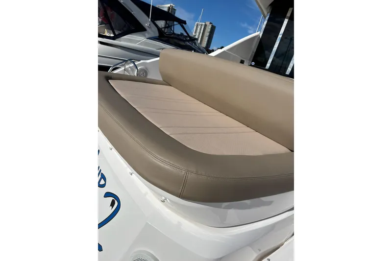 Slide: The Image of 2015 Regal 42 Sport Coupe boat with beige cushioned seating on deck. - 8