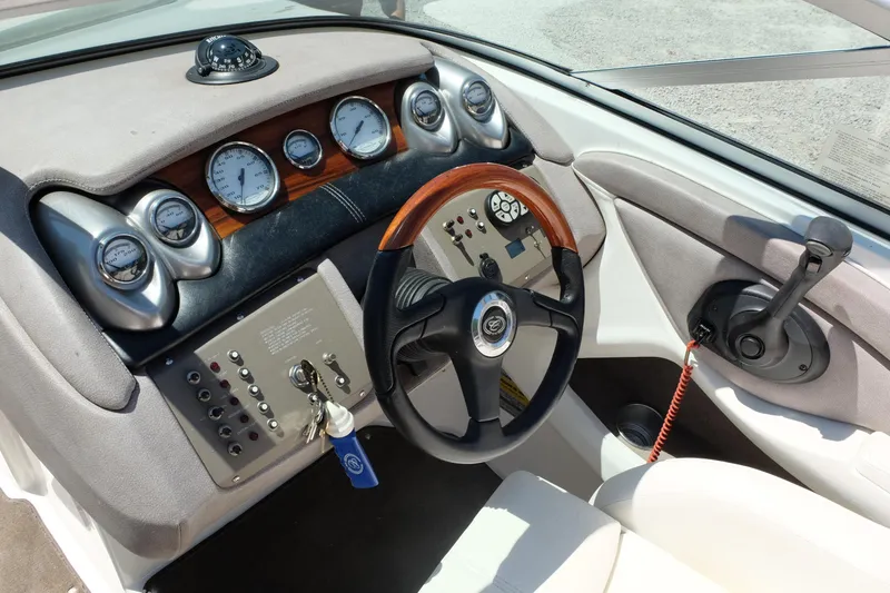 Slide: The Image of Dashboard of a 2004 Cobalt 200 boat with gauges and steering wheel. - 15