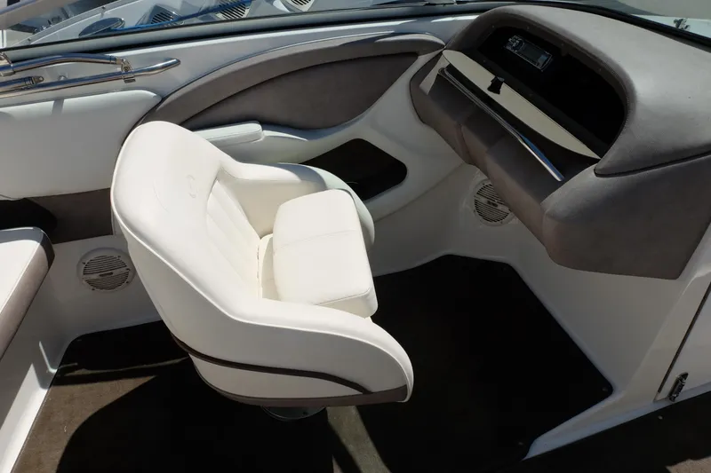 Slide: The Image of Interior of a 2004 Cobalt 200 boat with white seating and sleek dashboard design. - 17