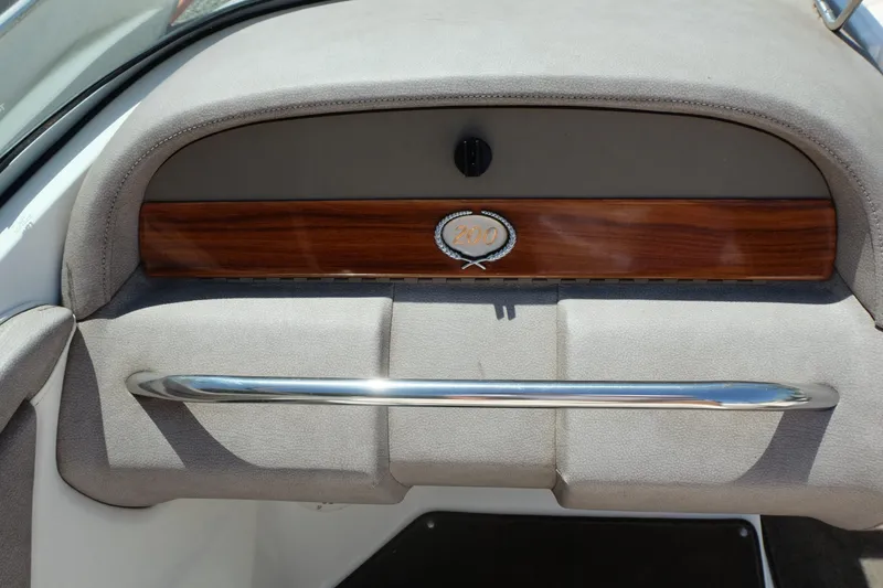 Slide: The Image of Dashboard of a 2004 Cobalt 200 boat with wood trim and chrome handle. - 18
