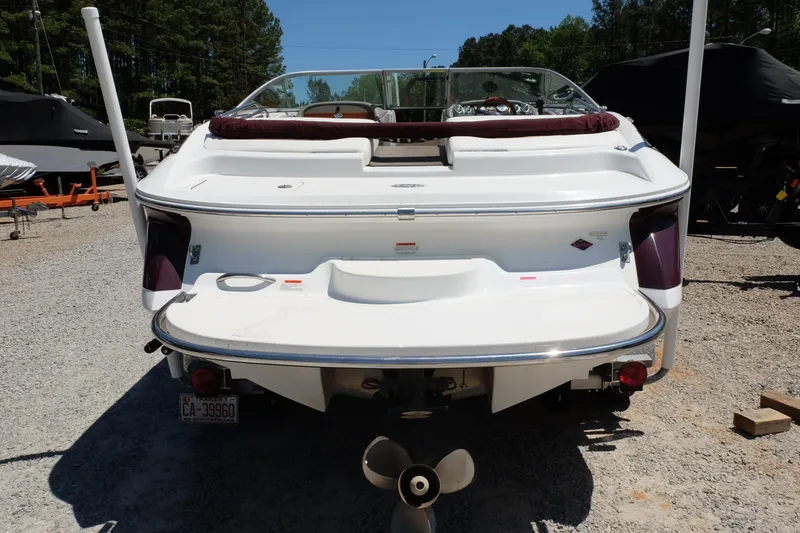 Slide: The Image of Rear view of a 2004 Cobalt 200 boat on a gravel lot. - 2