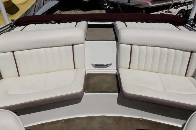 Slide: The Image of Interior seating of a 2004 Cobalt 200 boat with white upholstery. - 20